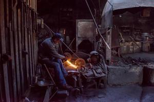 the blacksmith polishing metal products photo