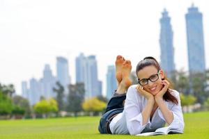 Young woman reading a book in the park photo