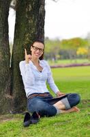Beautiful young woman with  tablet in park photo