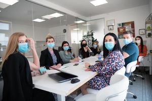 real business people on meeting wearing protective mask photo