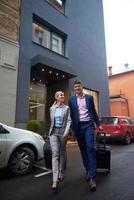 business people couple entering  hotel photo