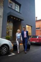 business people couple entering  hotel photo