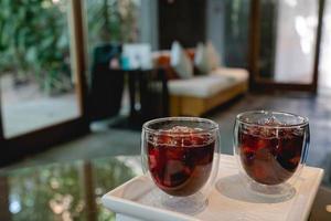 Welcome drink red mocktail and served on white wooden tray. photo