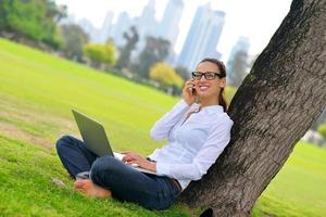 woman with laptop in park photo