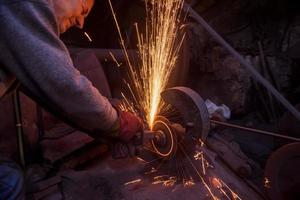 the blacksmith polishing metal products photo