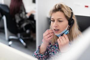 call center operator in medical mask photo