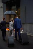 business people couple entering  hotel photo