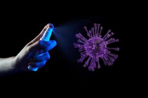 Hand using sanitizer spray, alcohol spraying disinfectant to stop spreading  coronavirus or COVID-19. photo