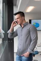 young business man speaking on  smart phone at office photo