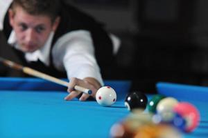 young man play pro billiard game photo