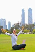 woman with laptop in park photo