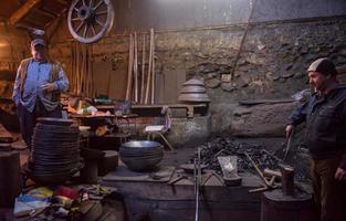 portrait of two generations traditional blacksmith photo