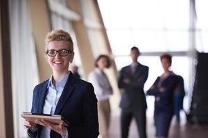 business woman  at office with tablet  in front  as team leader photo