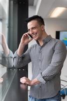 young business man speaking on  smart phone at office photo