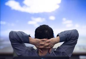 young man dreaming clouds on presentation photo