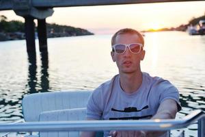 portrait of happy young man on boat photo