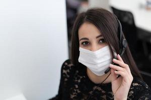 call center operator in medical mask photo