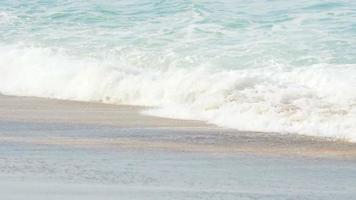 Waves on a sandy beach. May Khao beach in the north of Phuket, slow motion video