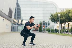 Male asian athlete doing fitness in the morning near the stadium photo