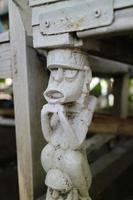 the legs of a chair with unique carvings in the form of miniature humans photo