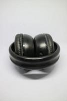 folded black bluetooth headphones on a white background photo