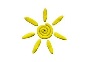 Plasticine yellow sun isolated on white background photo