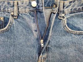 Zipper on jeans. Jeans texture. Unzipped jeans. photo