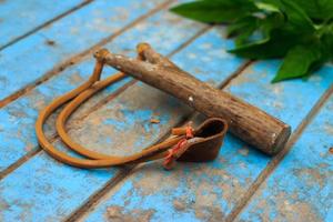 Slingshot on old blue wood photo