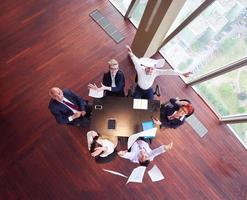 top view of business people group throwing dociments in air photo