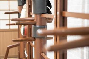 Wing Chun Wooden Dummy. Chinese kung fu practice dummy tool photo