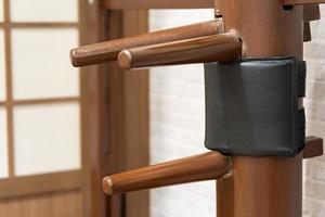 Wing Chun Wooden Dummy. Chinese kung fu practice dummy tool photo