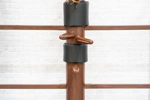 Wing Chun Wooden Dummy. Chinese kung fu practice dummy tool photo