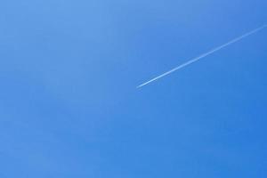 A passenger jet leaves a mark above the blue skies and the start of the airline after the kovic poisoning photo