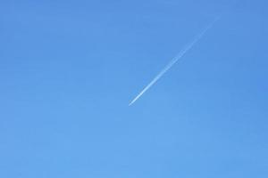 A passenger jet leaves a mark above the blue skies and the start of the airline after the kovic poisoning photo