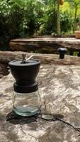 The drip coffee set includes coffee beans, drip kettle and a coffee grinder.  place on wooden table. photo