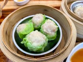 Dim sum top view and text input area, dim sum Chinese food in steamed bamboo is popular all over the world. photo