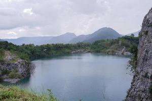 The limestone mountains after the concession explosion during the rainy season form a large and beautiful pond. photo