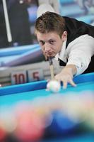 young man play pro billiard game photo