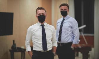 business team wearing crona virus protection face mask photo