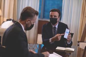 business people wearing crona virus protection face mask on meeting photo