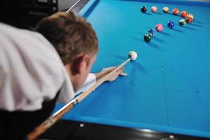 young man play pro billiard game photo