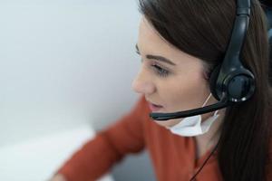 call center operator in medical mask photo