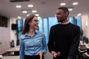 Two happy diverse professional executive business team people woman and African American man walking in coworking office. Multicultural company managers team portrait. photo