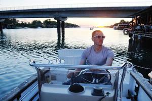 portrait of happy young man on boat photo