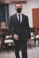 business man wearing protective face mask at office photo