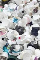 A pattern of many used and soiled nozzles from spray cans with aerosol paint. Background texture of the street art of drawing graffiti on the walls photo