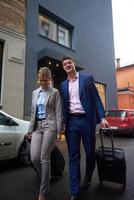 business people couple entering  hotel photo