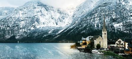 Panorama of Hallstatt old town city snow mountains and lake with reflection in the water in Winter season landscape Hallstatt, Austria photo