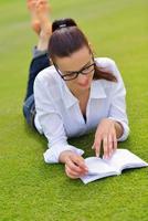 Young woman reading a book in the park photo