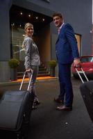 business people couple entering  hotel photo